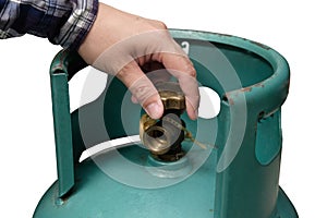 Male hand is closing the valve of lpg gas tank for safety. Files can use clipping parts