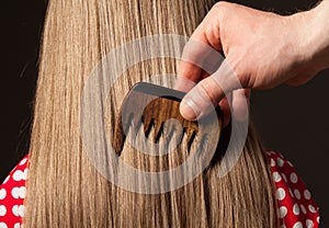 Male hand combing beautiful long hair
