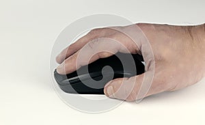 Male hand on computer mouse, close-up on white background