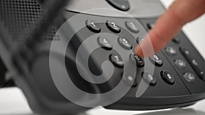 Male hand dialing telephone number