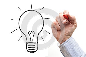 Male hand drawing light bulb over a White Background