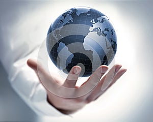 Male hand with a earth globe