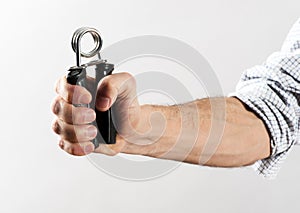 Male Hand Exercising Strength Using Hand Gripper photo