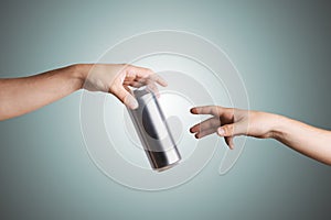 Male hand giving a beer can to another person