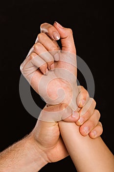 Male hand grabbing female wrist