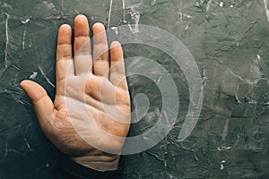 Male hand on gray table with open palm, top view. Palmistry concept