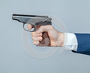 Male hand with a gun close up