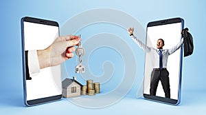 Male hand handing key from smartphone to happy european businessman with house and coins on blue background. Online home purchase
