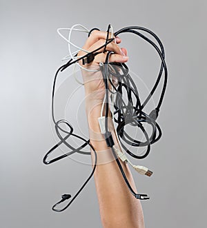 Male hand hold with lots of cable cords