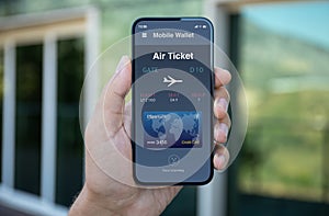 Male hand hold phone with airplane ticket application airlines screen