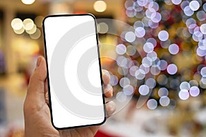 male hand hold phone isolated screen background of holiday lights