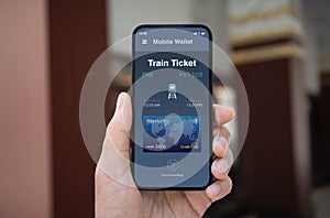Male hand hold phone with train ticket application on screen