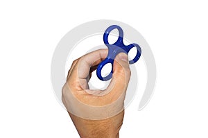Male hand holding a blue spinner on white isolated background.