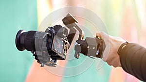 Male hand holding a camera on steadycam