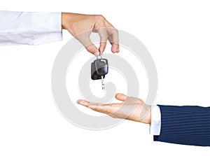 Male hand holding a car key and handing