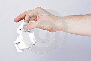 Male hand holding crumpled paper