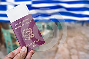 Male hand holding an european over the Greek flag background. Greek tourism opening concept