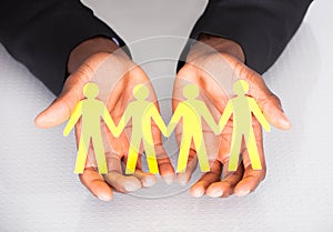 Male Hand Holding Family Cutout Shape