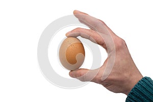 Male hand holding fresh chicken egg isolated on white