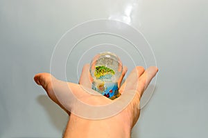 Male hand holding glass sphere