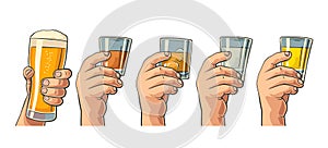 Male hand holding a glasses with beer, tequila, vodka, rum, whiskey and ice cubes.