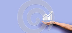 Male hand holding graph icon symbol.checking analyzing sales data growth graph chart and stock market on global networking.