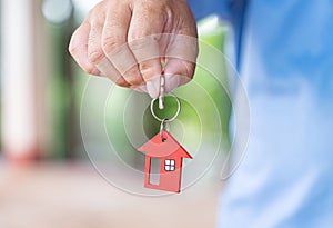 Male hand holding house key
