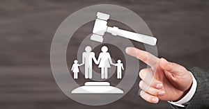 Male hand holding judge gavel with a family symbol. Family Law