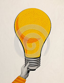 Male hand holding lightbulb like a brilliant idea generated by the most talented, contemporary collage. Business, startup, problem