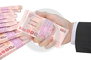 Male hand holding pack of baht note