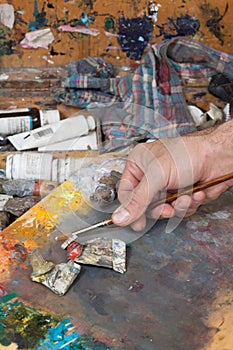 Male hand holding paint brush