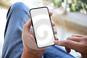 male hand holding phone with isolated screen in cafe