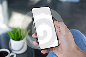 Male hand holding phone with isolated screen in cafe office