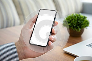 Male hand holding phone with isolated screen in the office