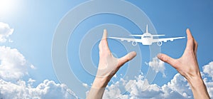 Male hand holding plane airplane icon on blue background. Banner.nline ticket purchase.Travel icons about travel planning,