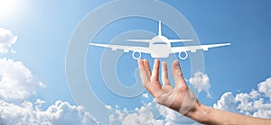 Male hand holding plane airplane icon on blue background. Banner.nline ticket purchase.Travel icons about travel planning,