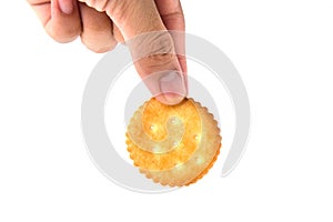 Male hand holding round cracker cookie isolated on white background