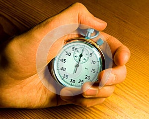 Male hand holding the stop-watch