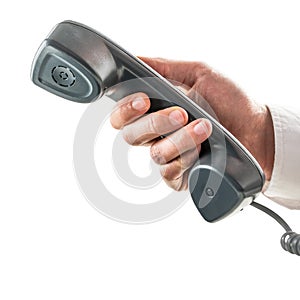 Male hand holding a telephone receiver