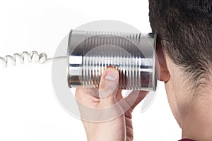 Male hand holding a tin can phone to his ear