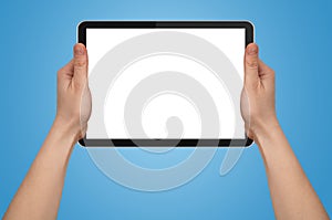 A male hand holding a touchpad pc