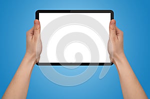 A male hand holding a touchpad pc