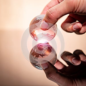 Male hand holding world globe crystal glass