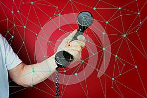 Male hand holds a telephone receiver Handset from vintage apparatus on red background, concept of anonymous psychological