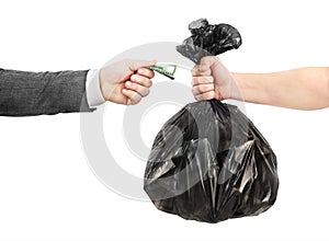 A male hand in a jacket transfers money to the other hand in exchange for a garbage bag