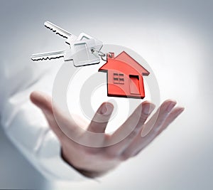Male hand with keys and a house shaped key chain