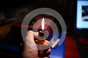 Male hand lighting a cigarette lighter