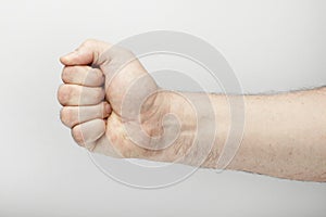 Male hand makes a fist