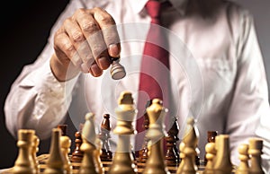 Male hand moving pawn on chess board, starting game. Making business decision concept