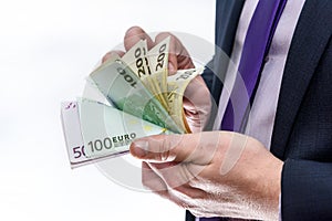 Male hand offering euro banknotes close up